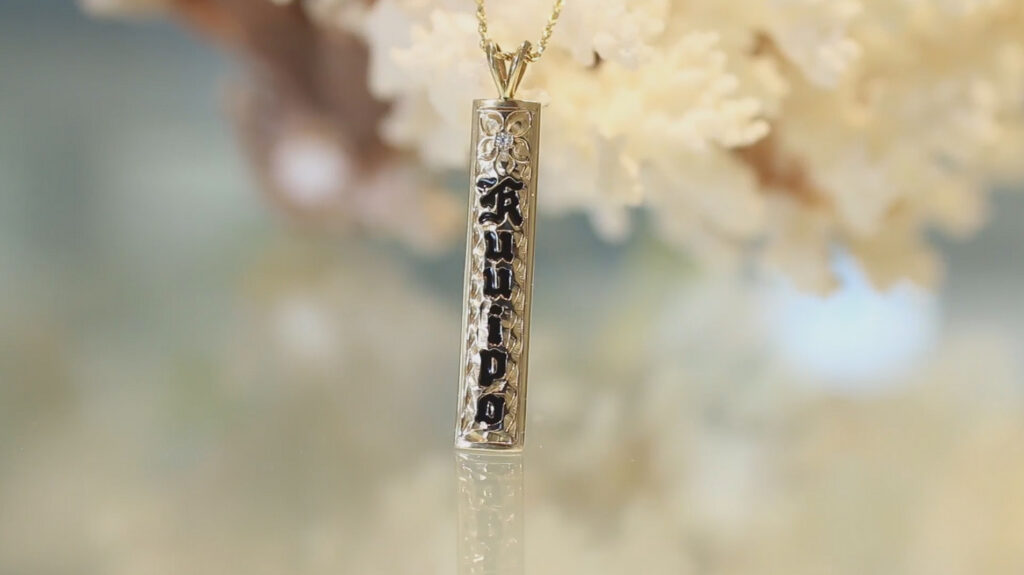 Vertical Hawaiian Pendant with diamond centered plumeria flower